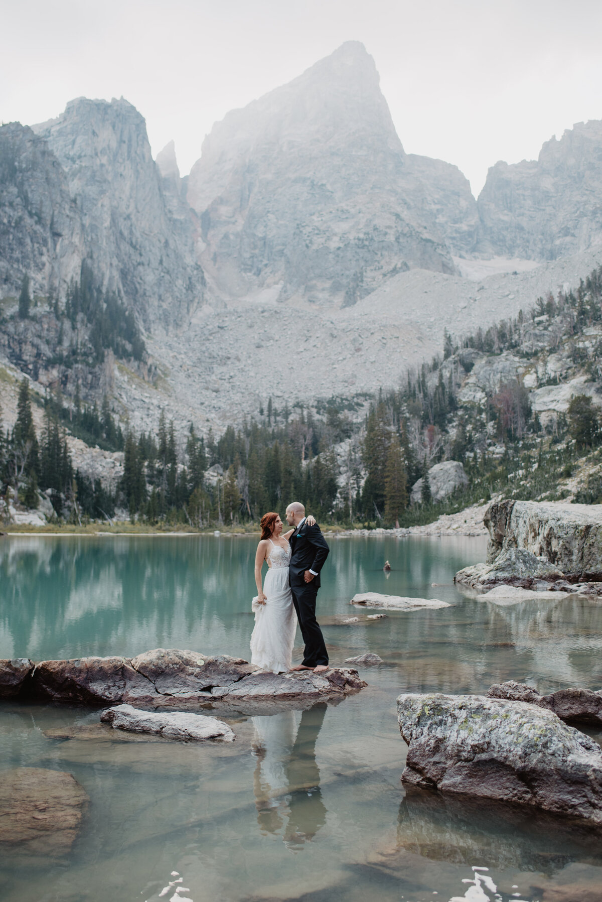 Jackson Hole Photographers capture bride embracing husband