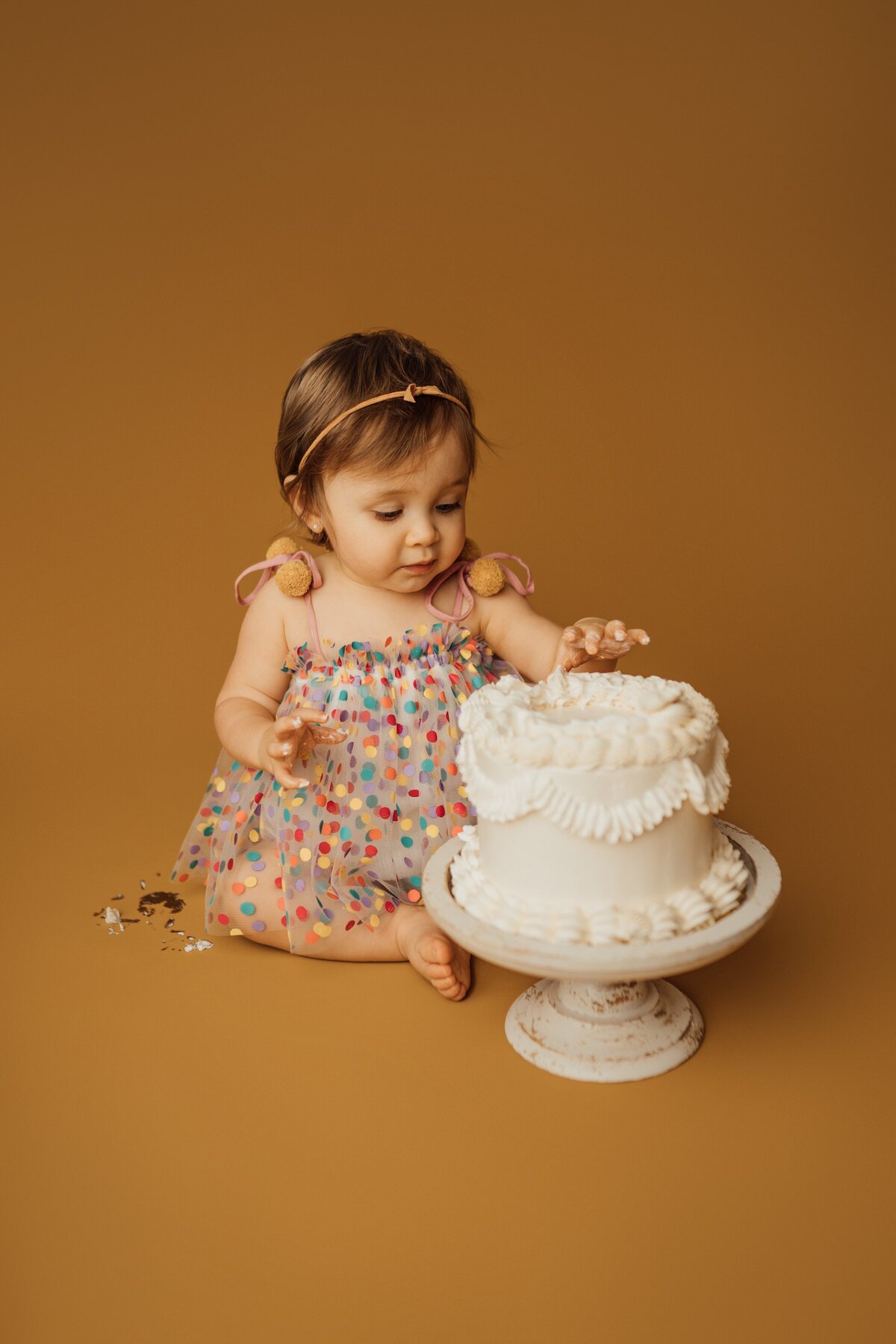 girl eats cake to celebrate first birthday at studio in tampa