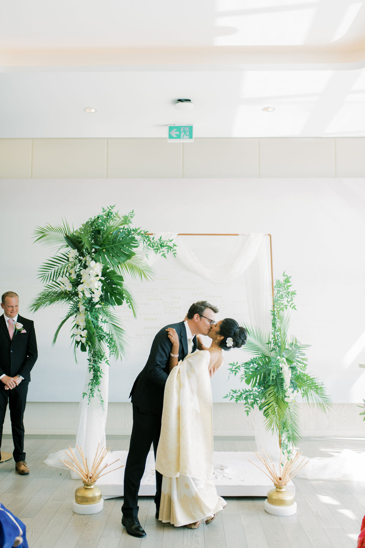 Bride and groom kiss at their wedding at the pearle hotel