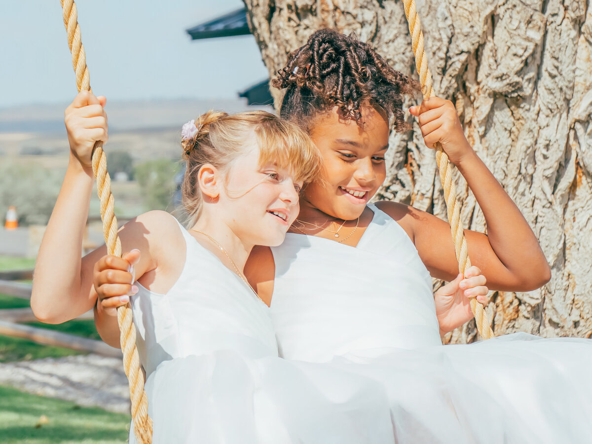 Flower girls on a swing during a wedding at Half Moon Bay, California