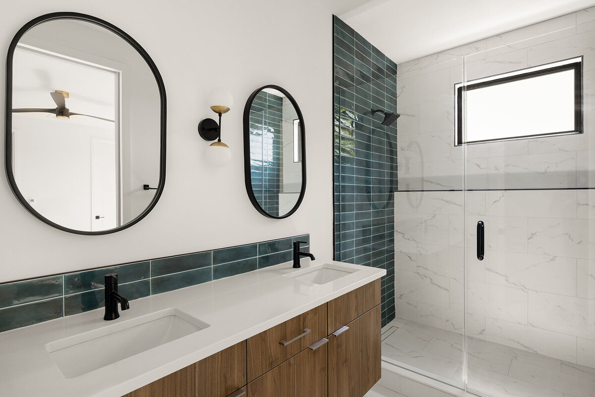 double vanity with white countertops and natural wood cabinetry