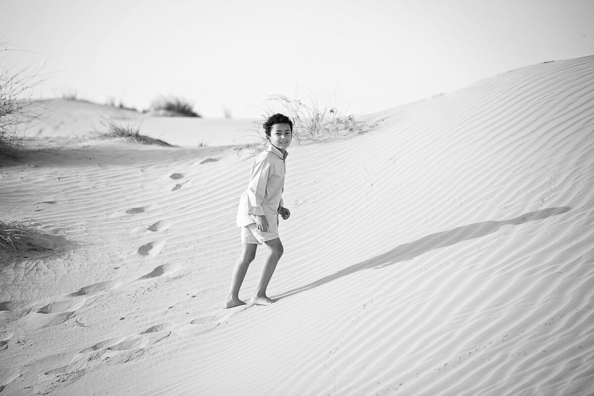 Boy walking the dunes_Saskachewan