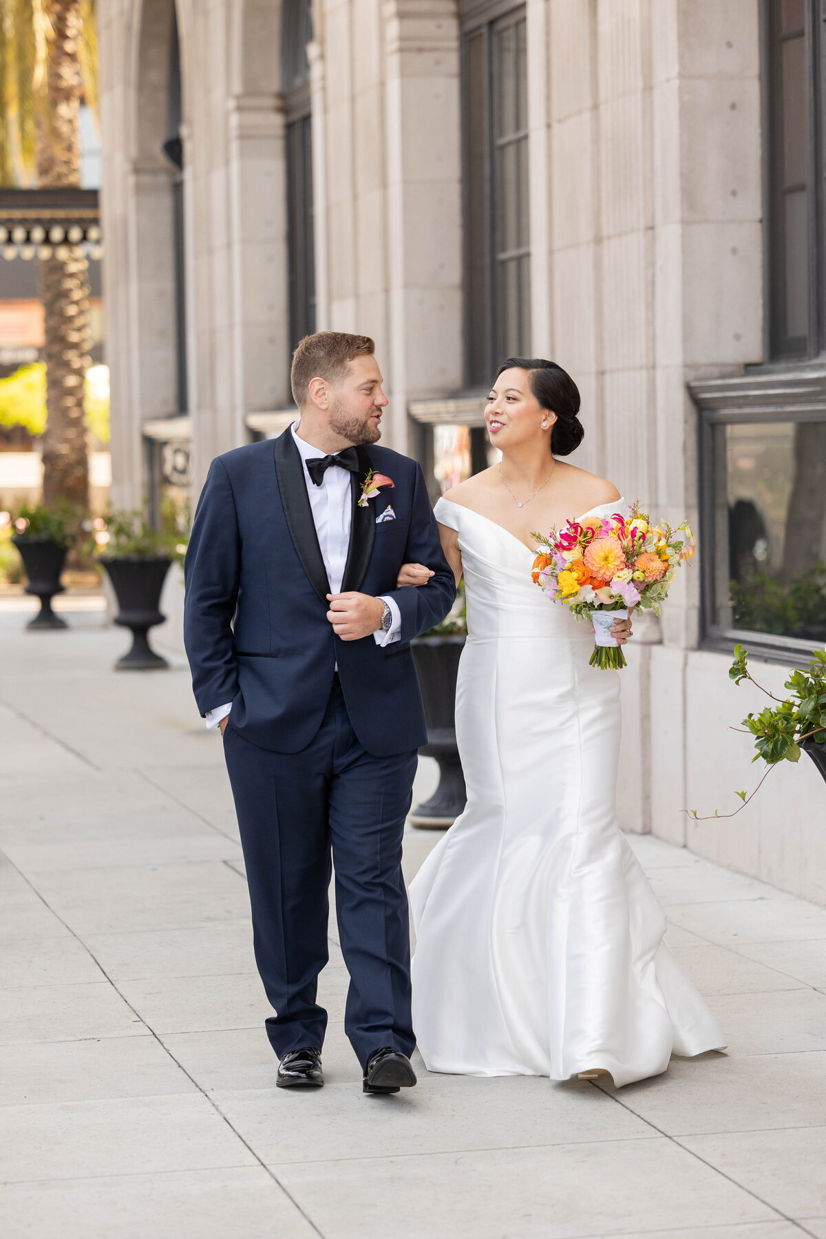 Bride and groom walking outside the CULVER hotel