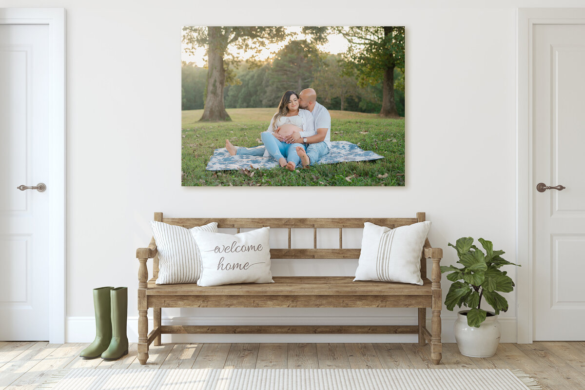 Expecting couple sit on a blanket in the glowing sun. Captured by Amanda Touchstone, an Atlanta maternity photographer
