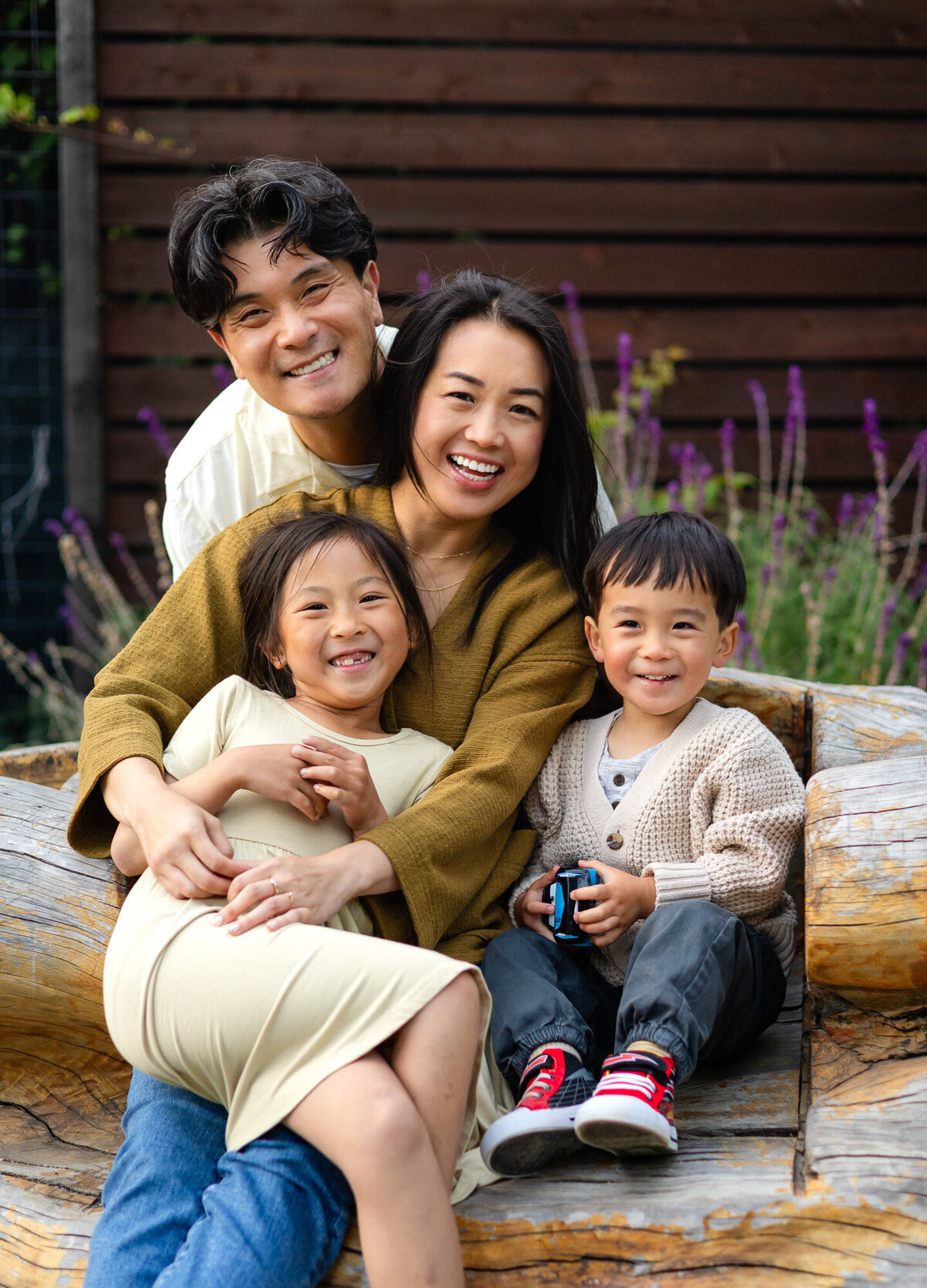 Happy family of four smiling close together on wooden bench – Bay Area Family Portfolio - Ellobelle Photography Family Photographer