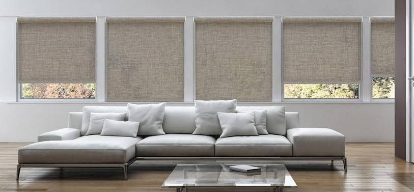 Row of motorized LightGuard 360 blackout roller shades raised to the same height in a Las Vegas great room