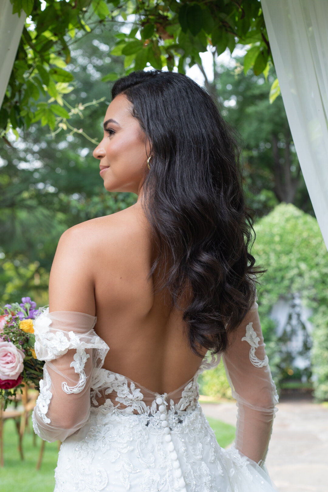 Elegant bride captured in a serene moment at an outdoor garden ceremony in Austin, Texas Hill Country, photographed by Marina Lazarine Photography.