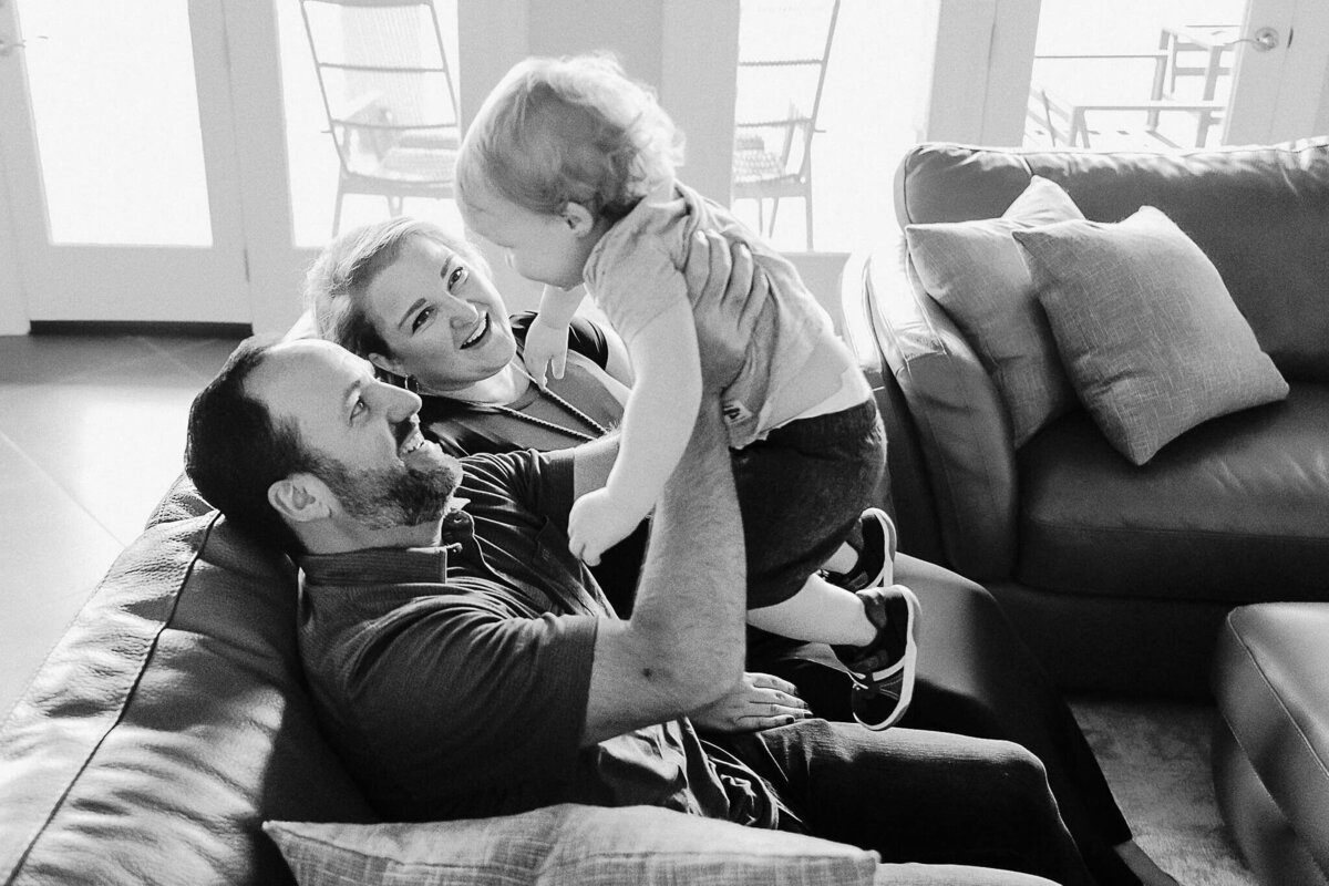 Black and white photo of family on the couch