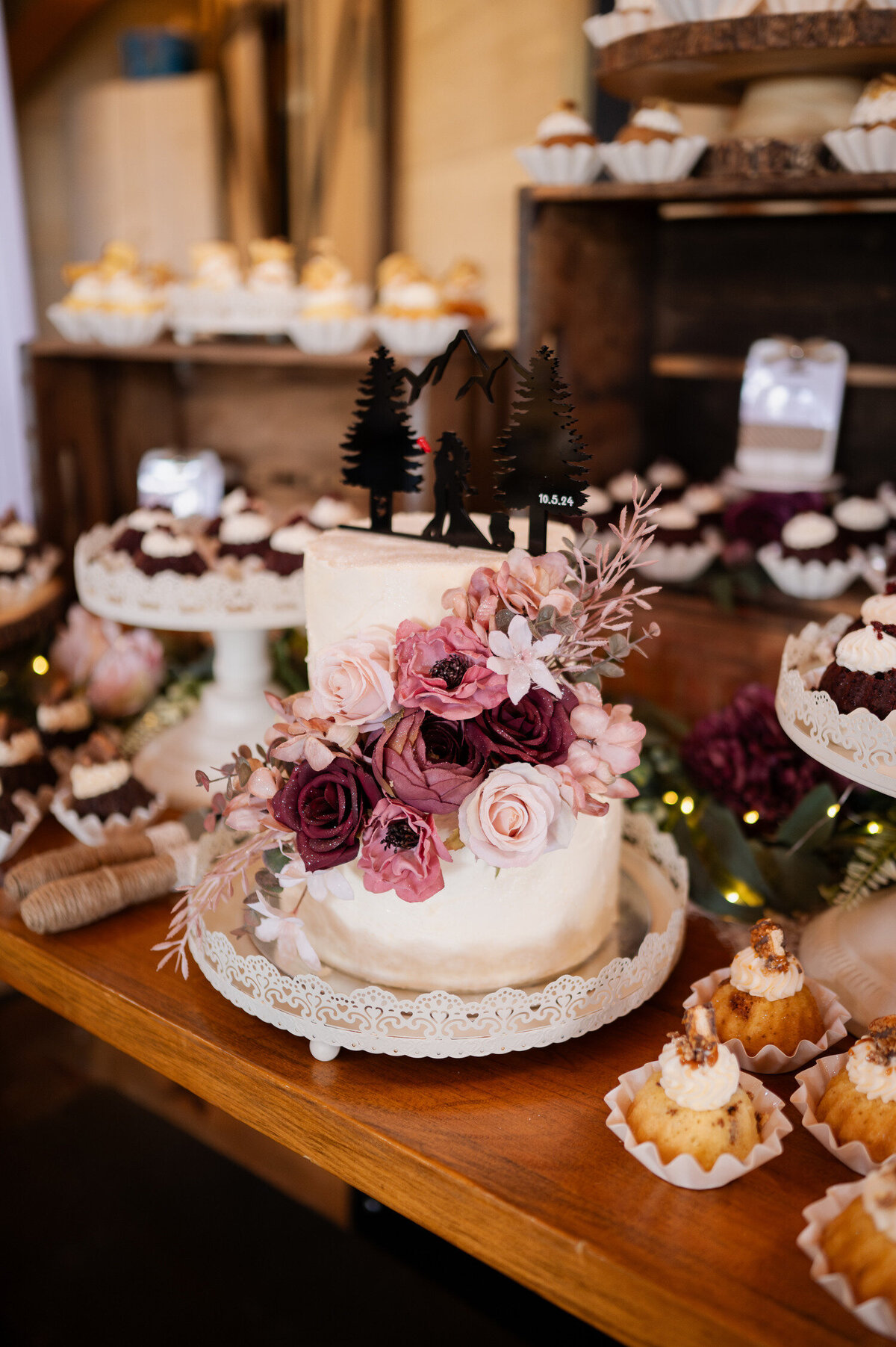 The wedding cake and dessert table during a wedding at Country Meadows Barn in Fort Ann, NY.