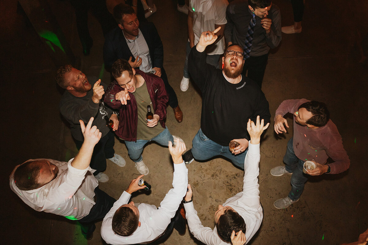 birds eye view of groom and groomsmen dancing at wedding