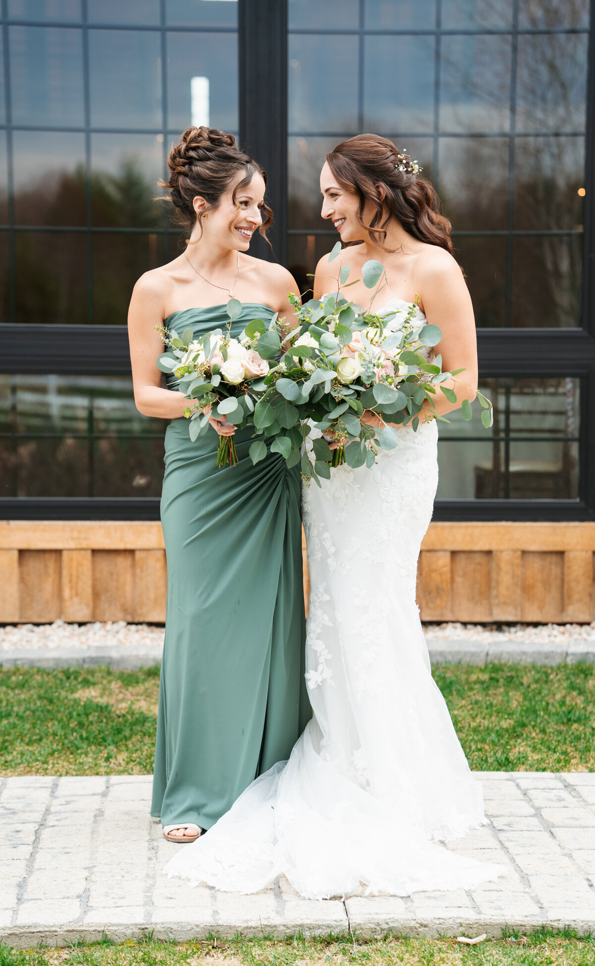 Bride and groom laughing together during wedding day portraits