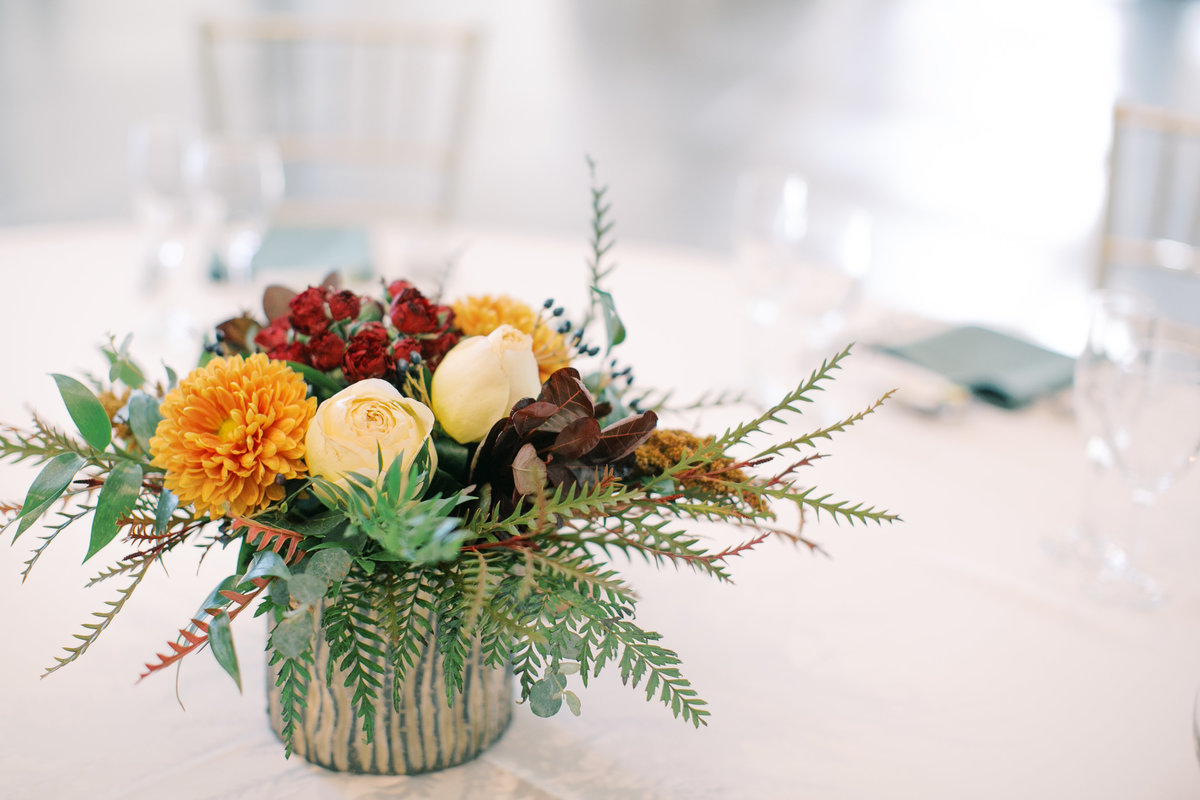 Fall themed cocktail table arrangement  in a gold mercury glass vase