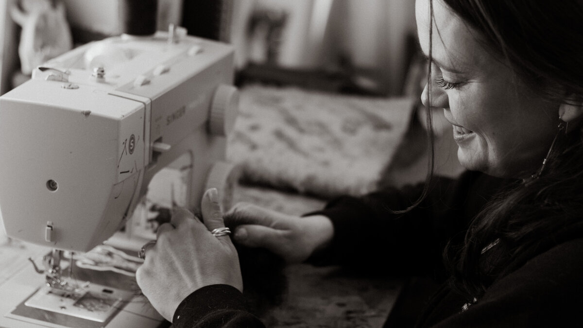 black and white image Natalie at sewing machine