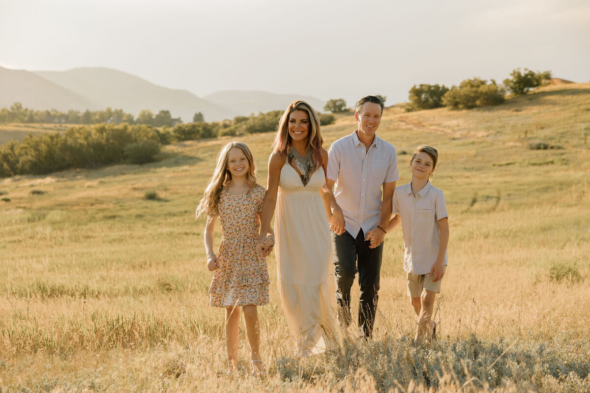 A beautiful family portrait session during golden hour in the foothills of Colorado, capturing the natural beauty of the landscape and the warmth of family connection.