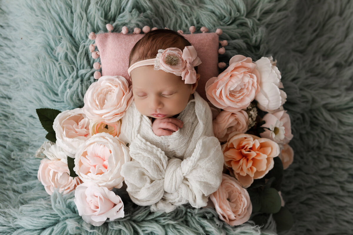 Photos by Ashleigh offers professional studio newborn photography services in Oklahoma City. Capturing precious moments of your little one with expertise and care. Book your session today!