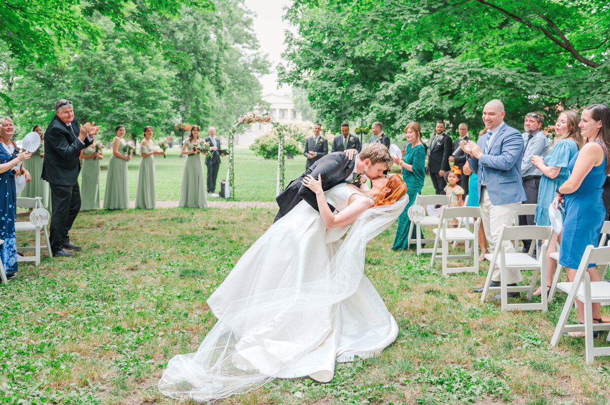 bride and groom kissing at end of the aisle after ceremony