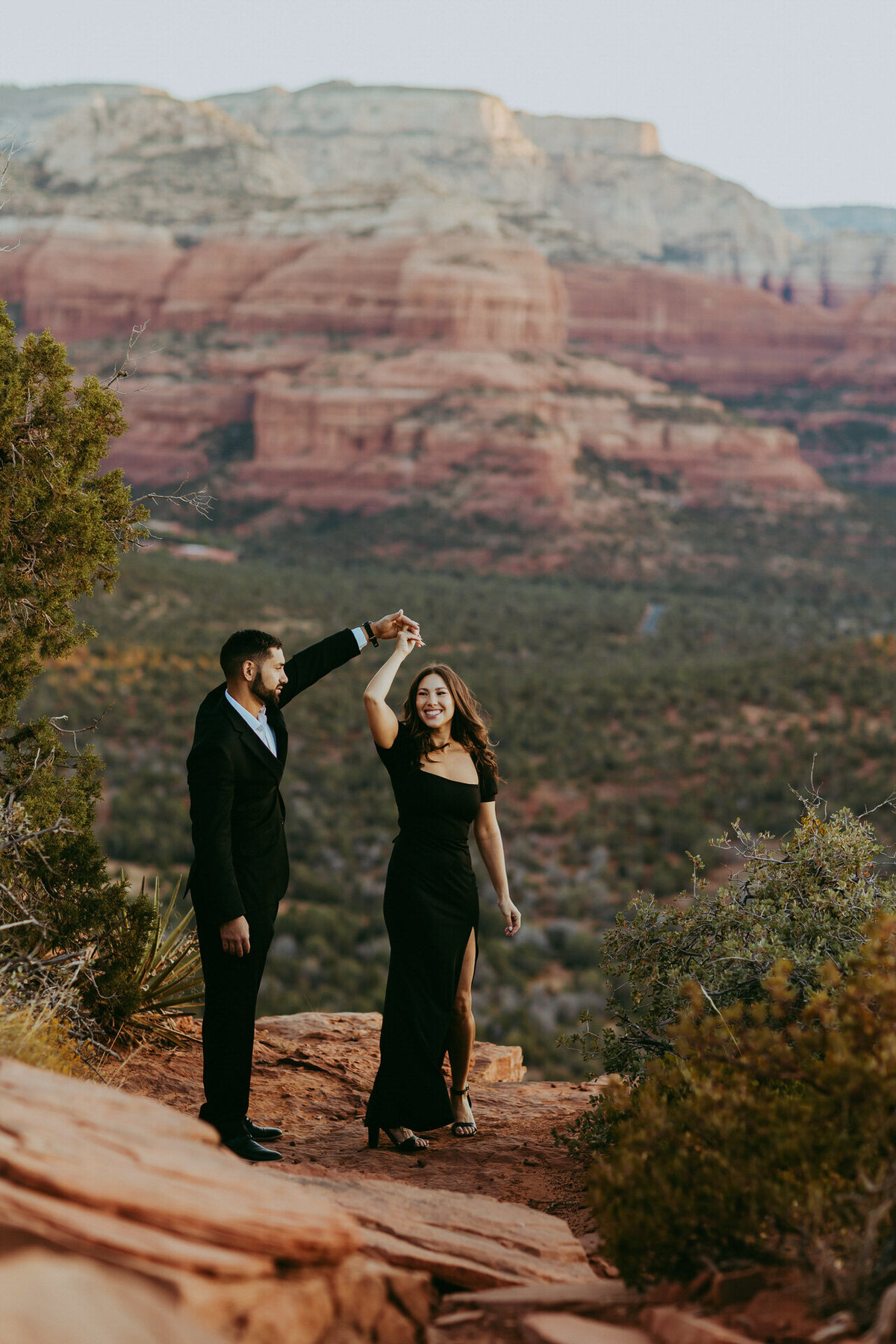 couple taking photos on doe mountain in sedona