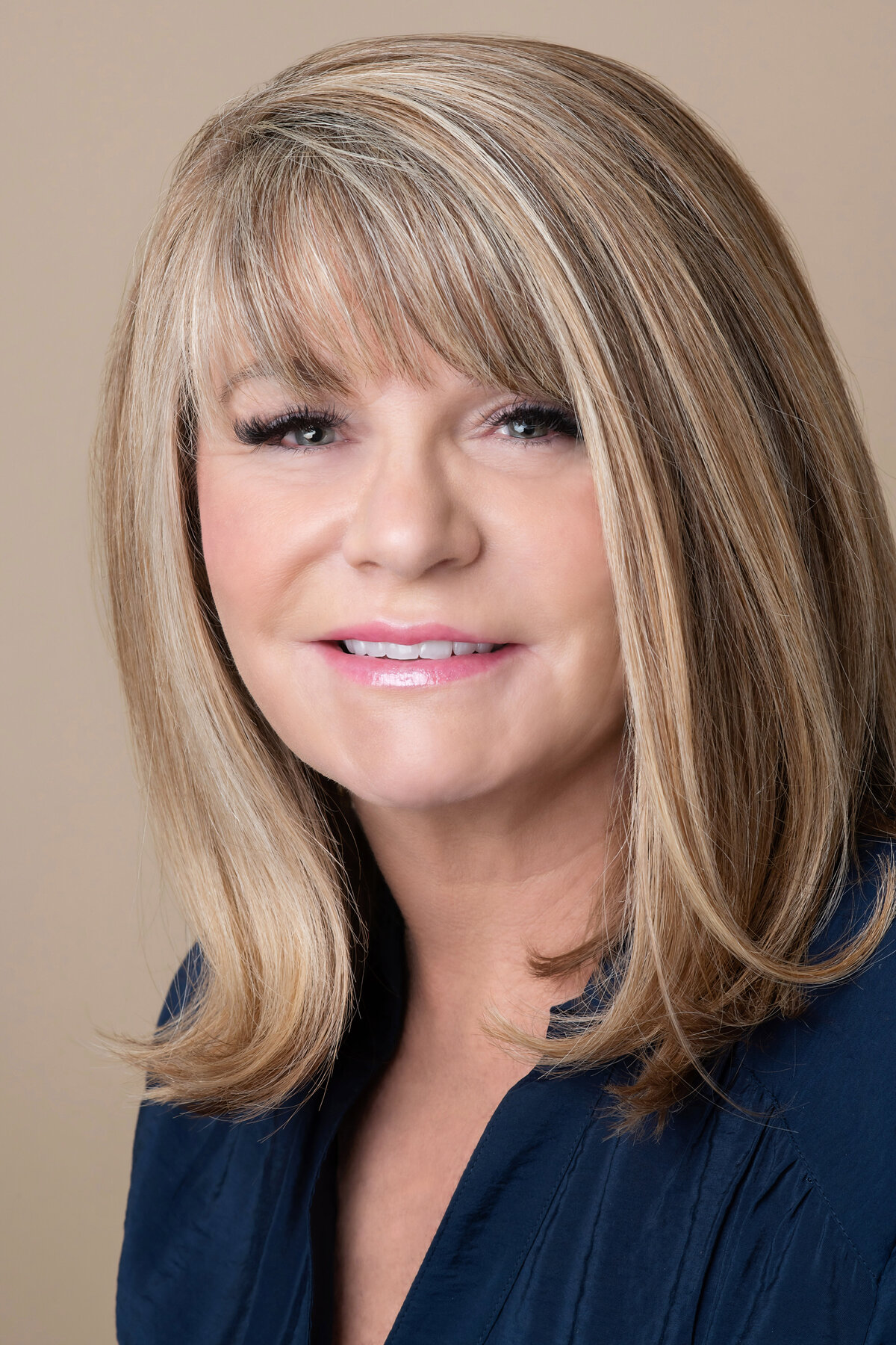 headshot on beige background