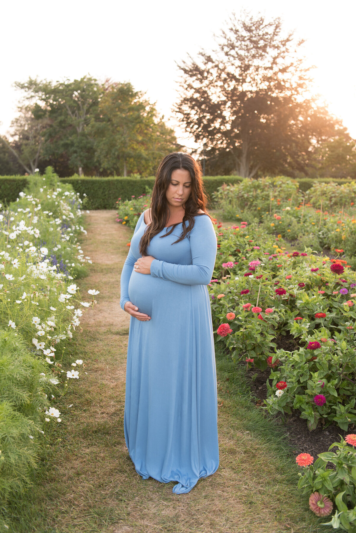 Pregnant mother in blue dress in garden