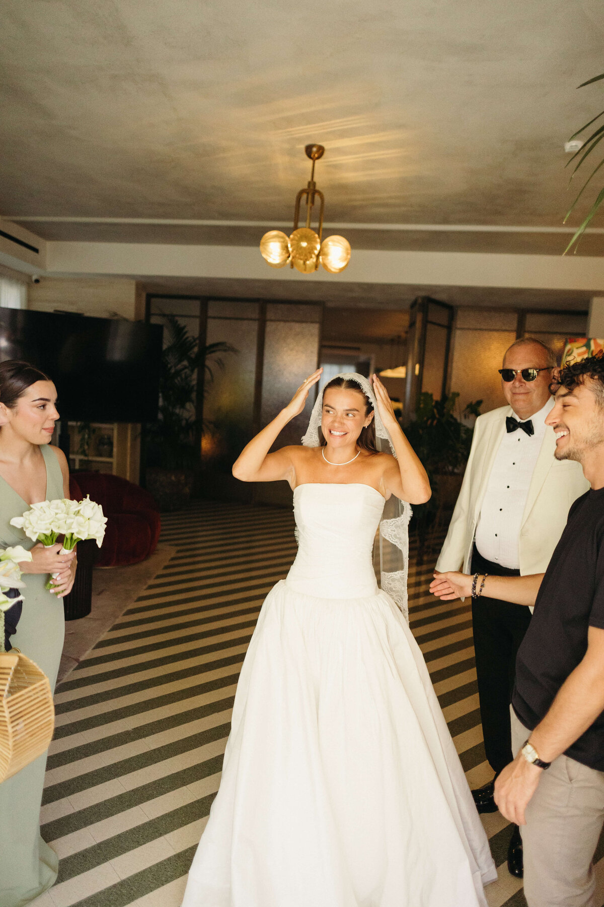 Bride adjusting veil in Soho House Rome lobby before the ceremony