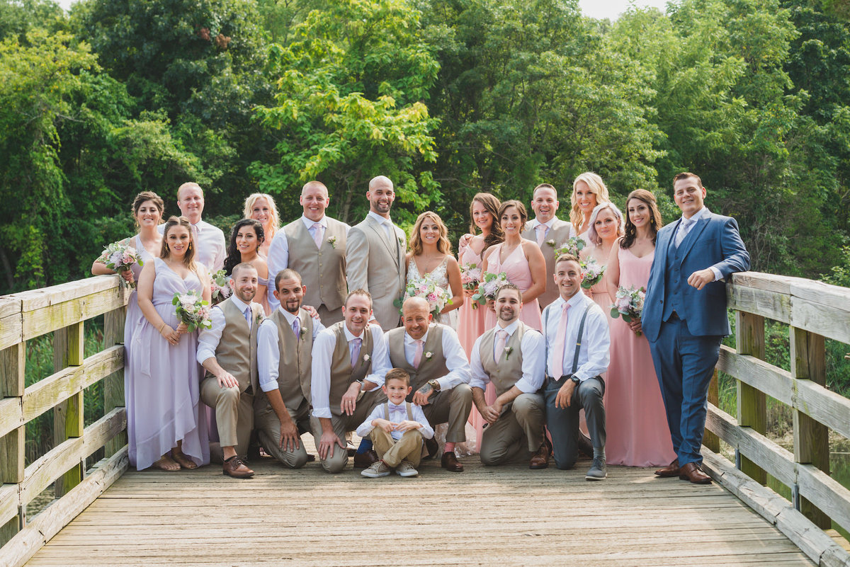 photo of full bridal party on boardwalk bridge from wedding at Pavilion at Sunken Meadow
