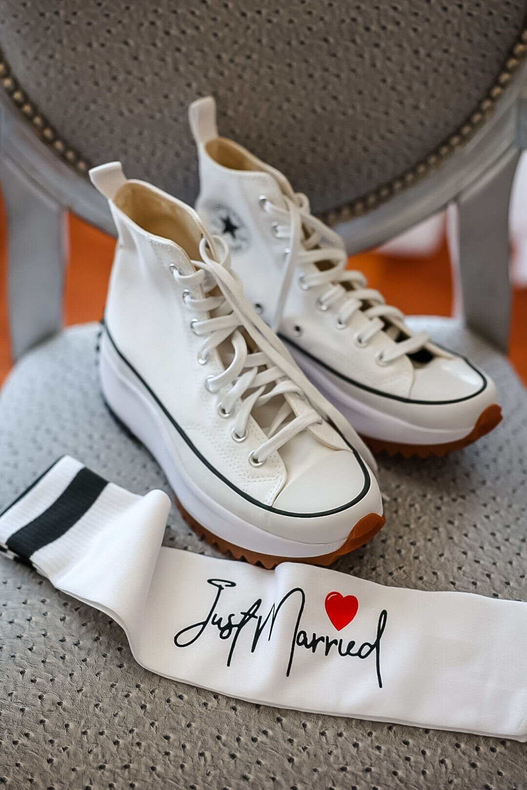 just married socks by converse high tops  on gray chair