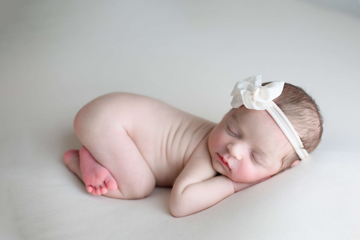 Newborn baby girl sleeping with headband