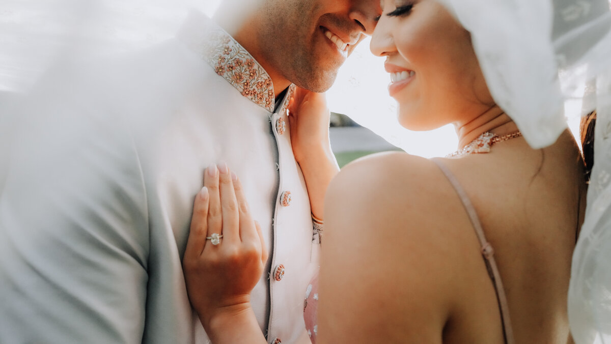 Picture of wedding couple with the bride's hand resting on the groom's chest
