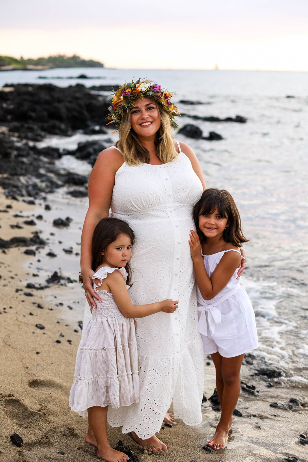 Mom with two daughters on beach for family pictures in hawaii