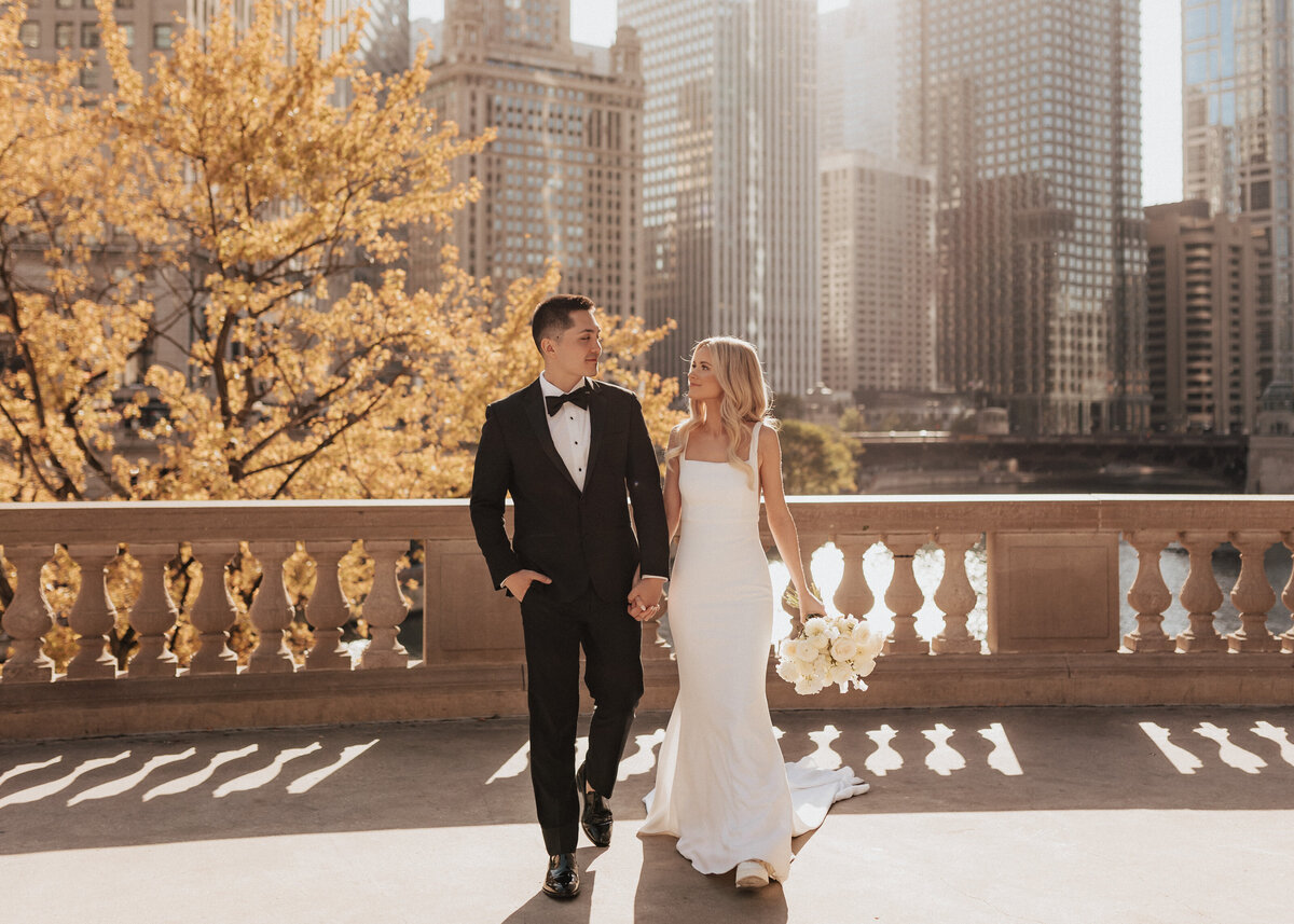 Bride and groom walking at The Wrigley Building in Chicago, IL