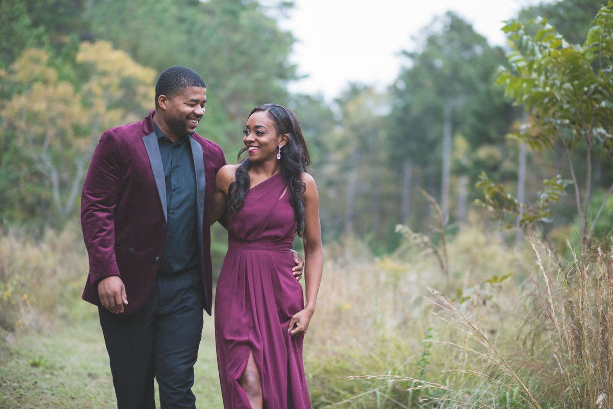 Formal dressed couple in field during engagement session
