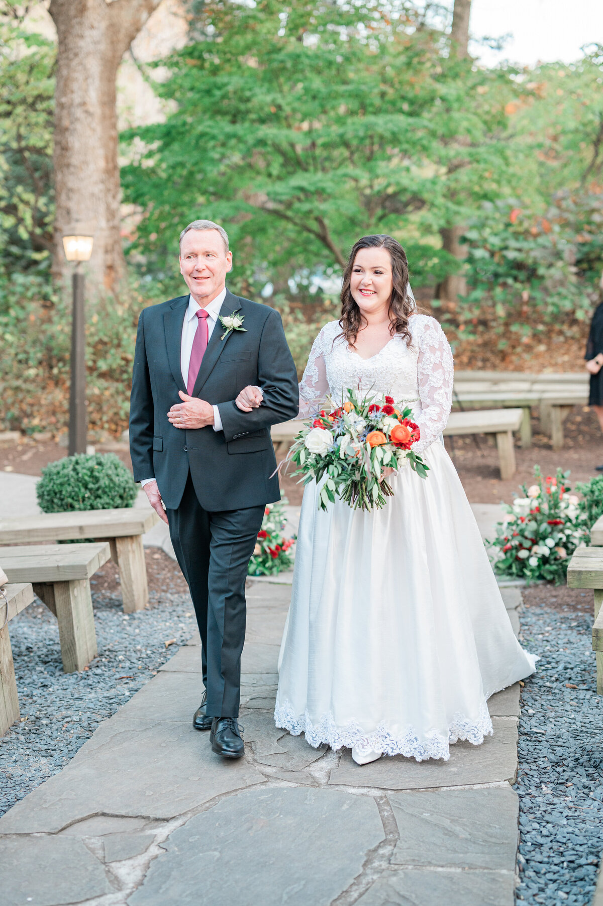 A father walking down the aisle with their daughter on her wedding day