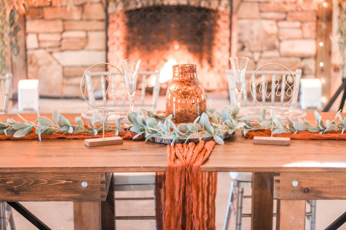 Table setting with greenery and a copper vase centerpiece