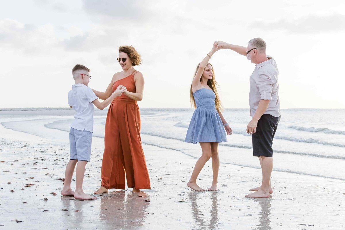 family-dancing-on-beach