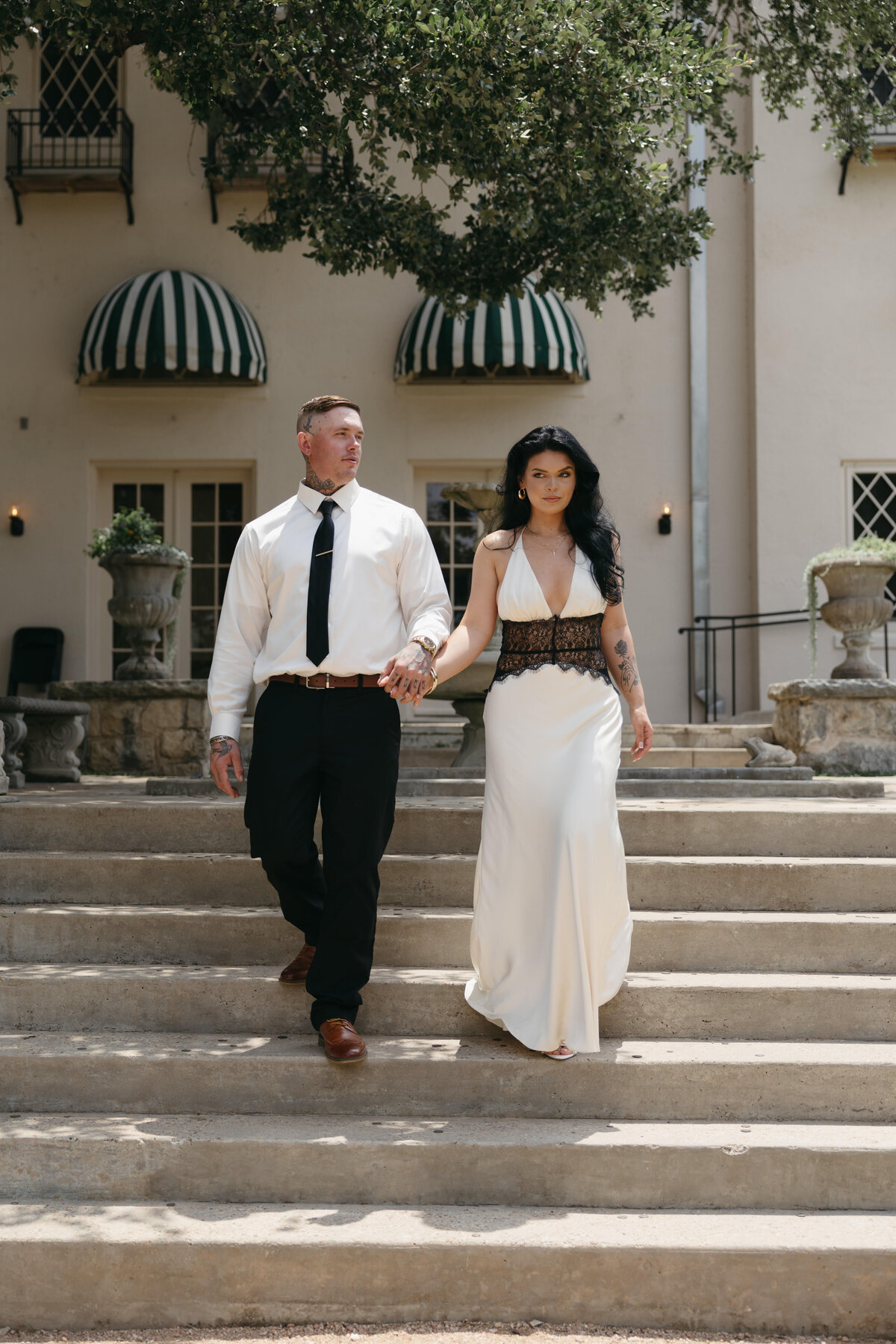 Wedding photographer capture bride and groom walking down stairs at Laguna Gloria