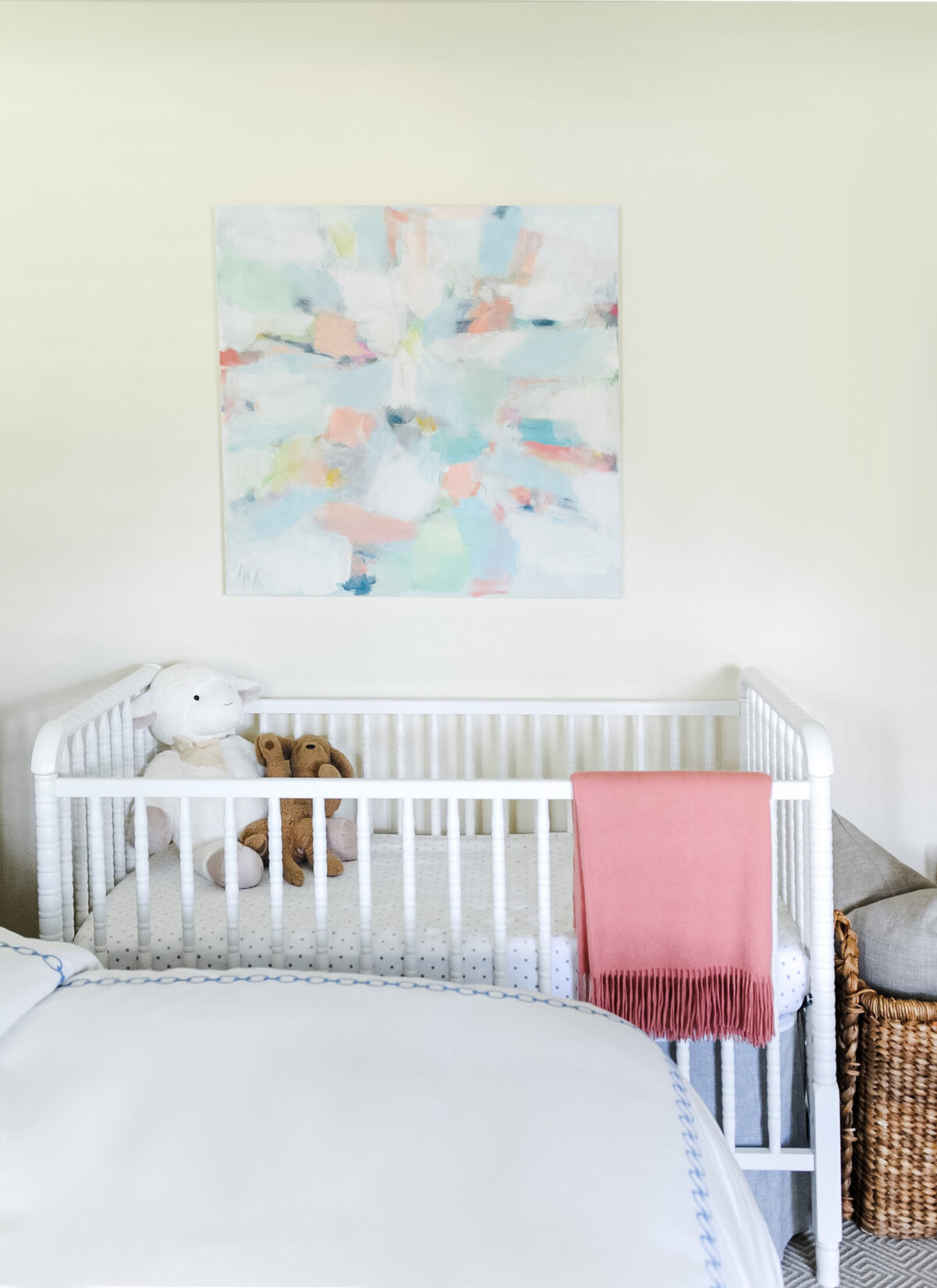 Nursery design inspiration featuring a  white crib and abstract artwork