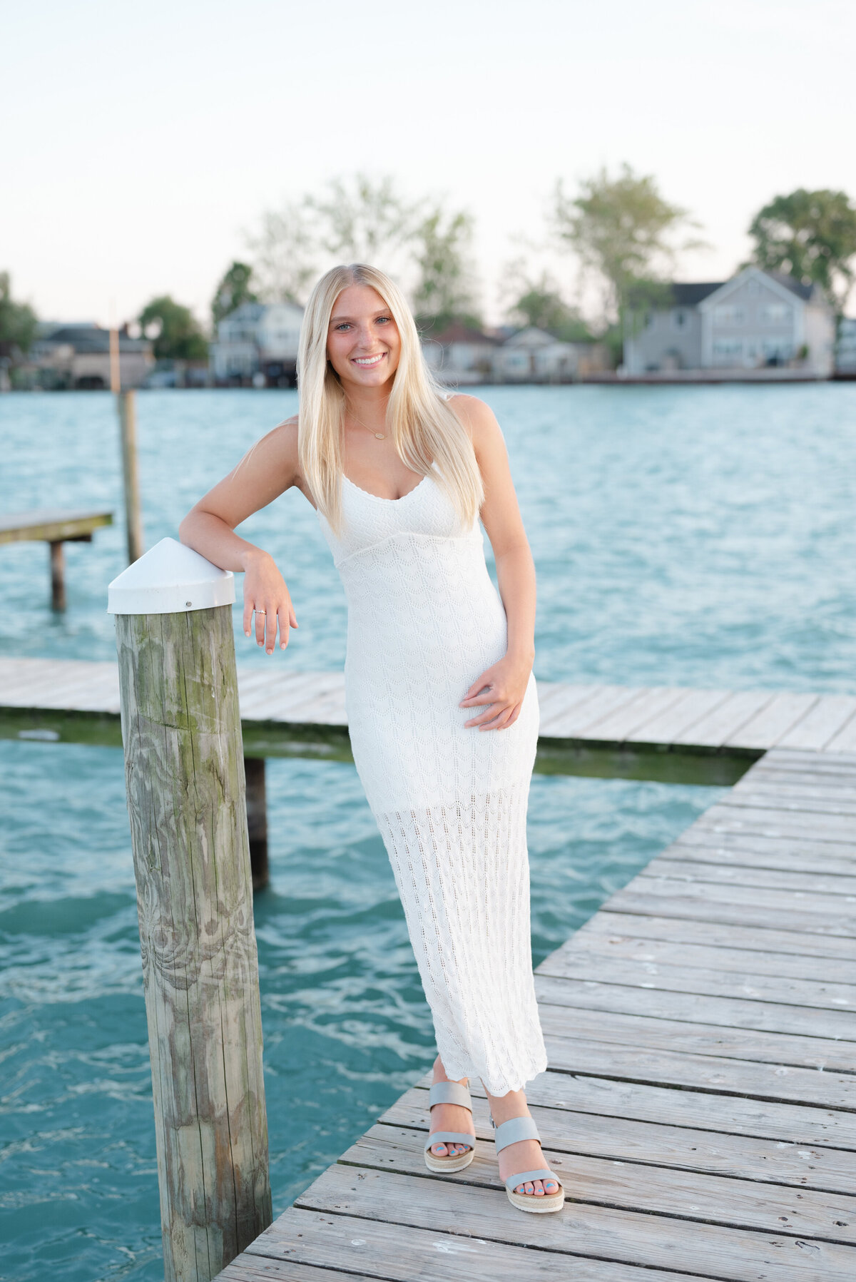 smiling-senior-girl-on-dock-sunset