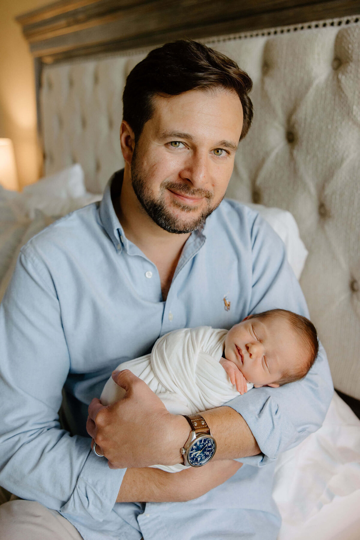 father holding newborn son during in home lifestyle newborn session