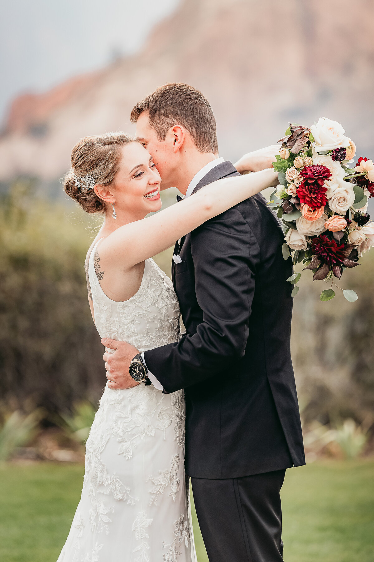 A bride and groom embrace at the Garden of the Gods Resort