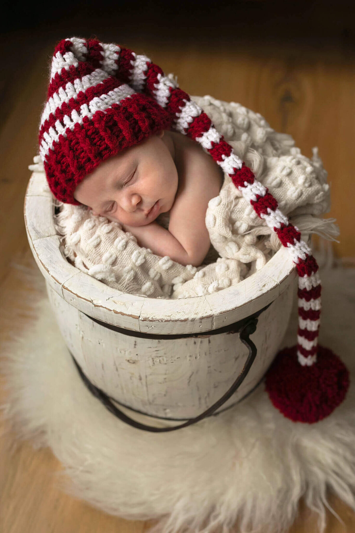 NJ Newborn photos of baby in sleepy Christmas cap