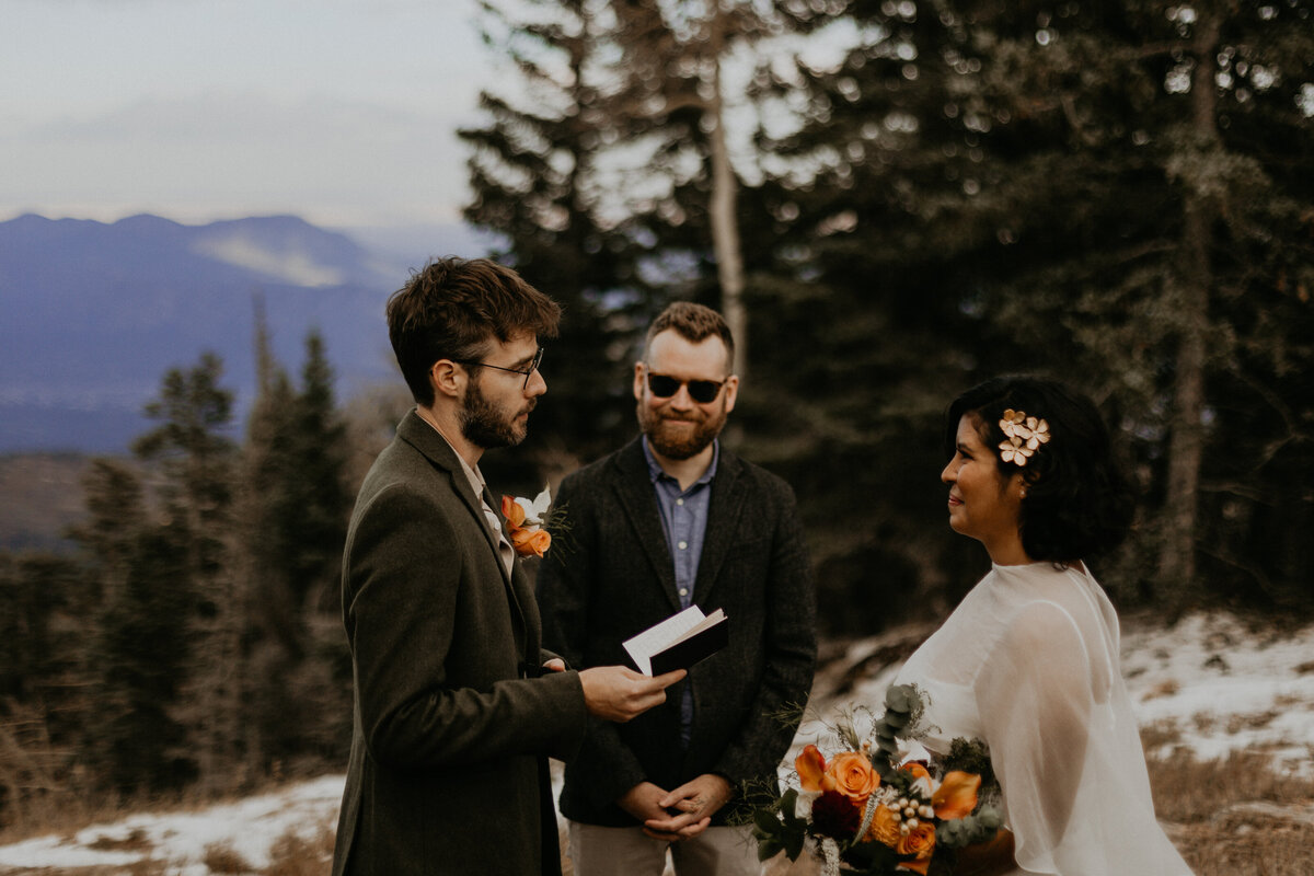 bride and groom exchanging vows and rings on the Sandia Mountains