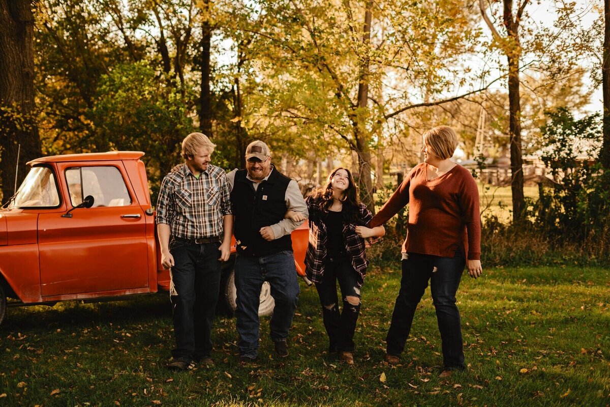 family-photo-fall-orange-truck-iowa-Storyteller-Collective-Photo-Co