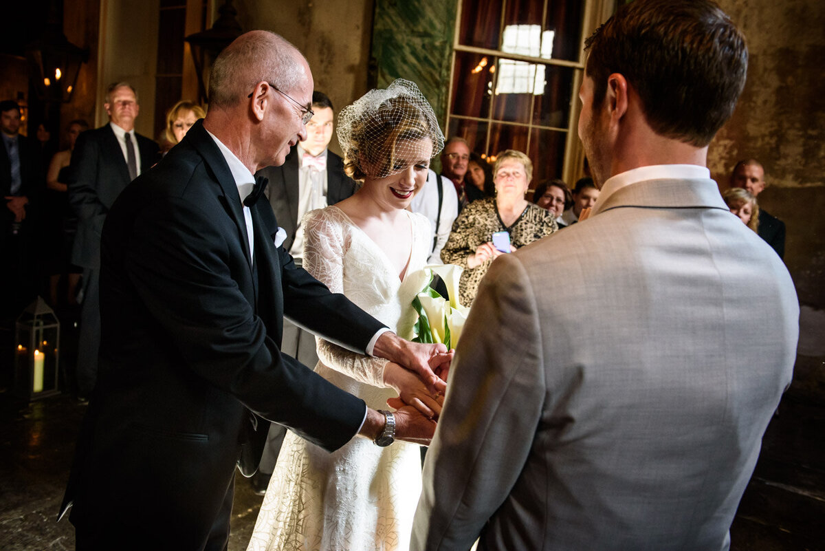 Father gives away bride at wedding ceremony