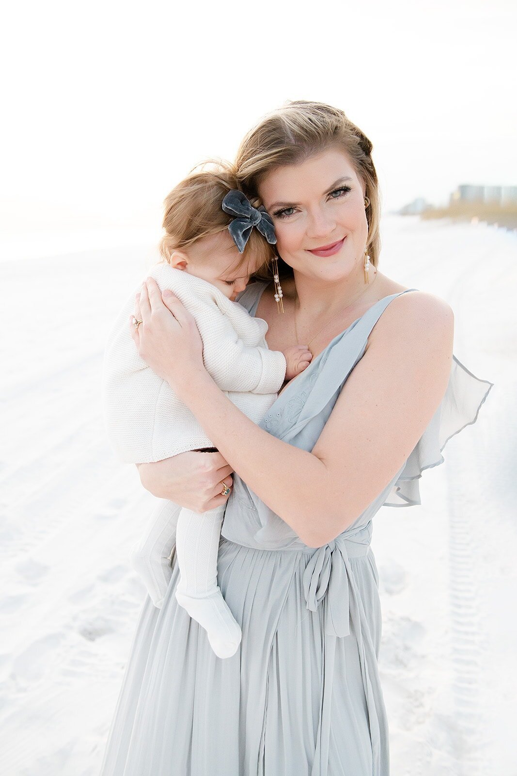 a mother snuggling her baby during destin family photos