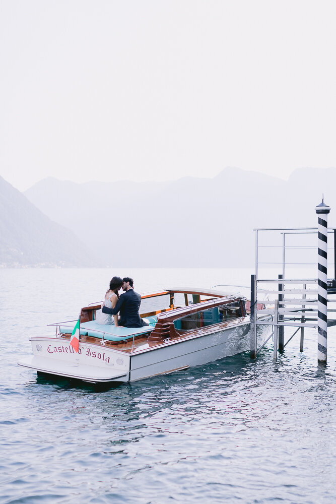 Bride and groom sitting in a boat on Lake Como