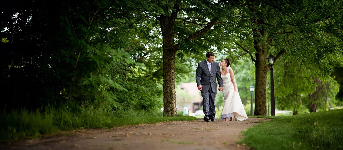 Bride and groom walking in the woods
