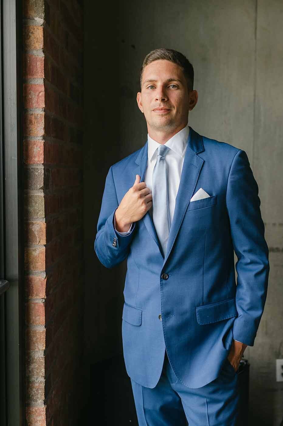 wedding photograph of Groom in navy blue suit