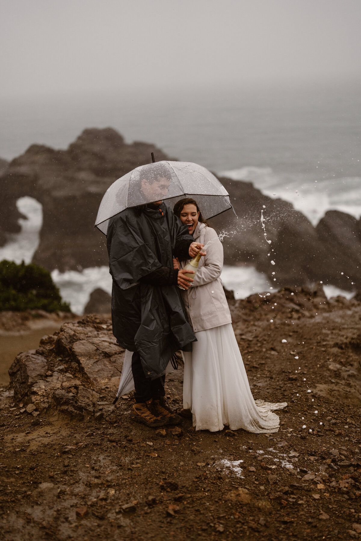 bride and groom under umbrella