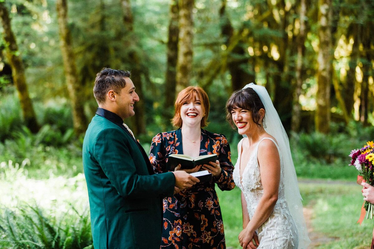 A couple laughing at a joke their officiant told during their Washington Elopement.