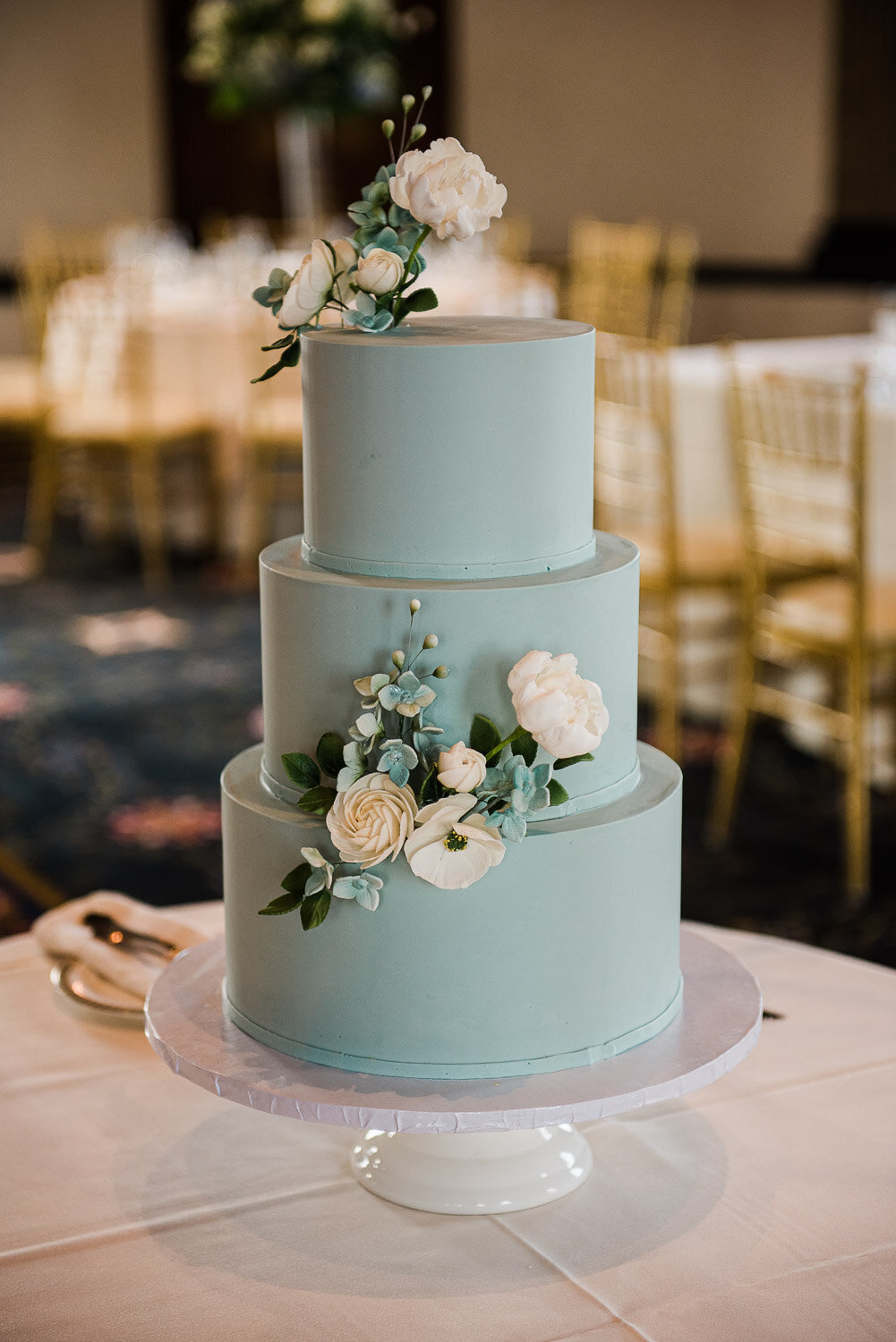aqua wedding cake with flowers in Graduate Providence ballroom